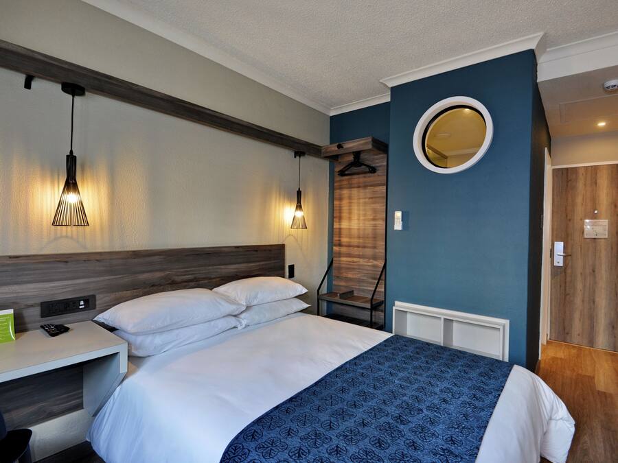 Desk, laptop workspace, blackout drapes, iron/ironing board