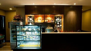 A bar area with a refrigerated display case and shelves of bottles. - 41 Suite Bangkok (Bangkok)