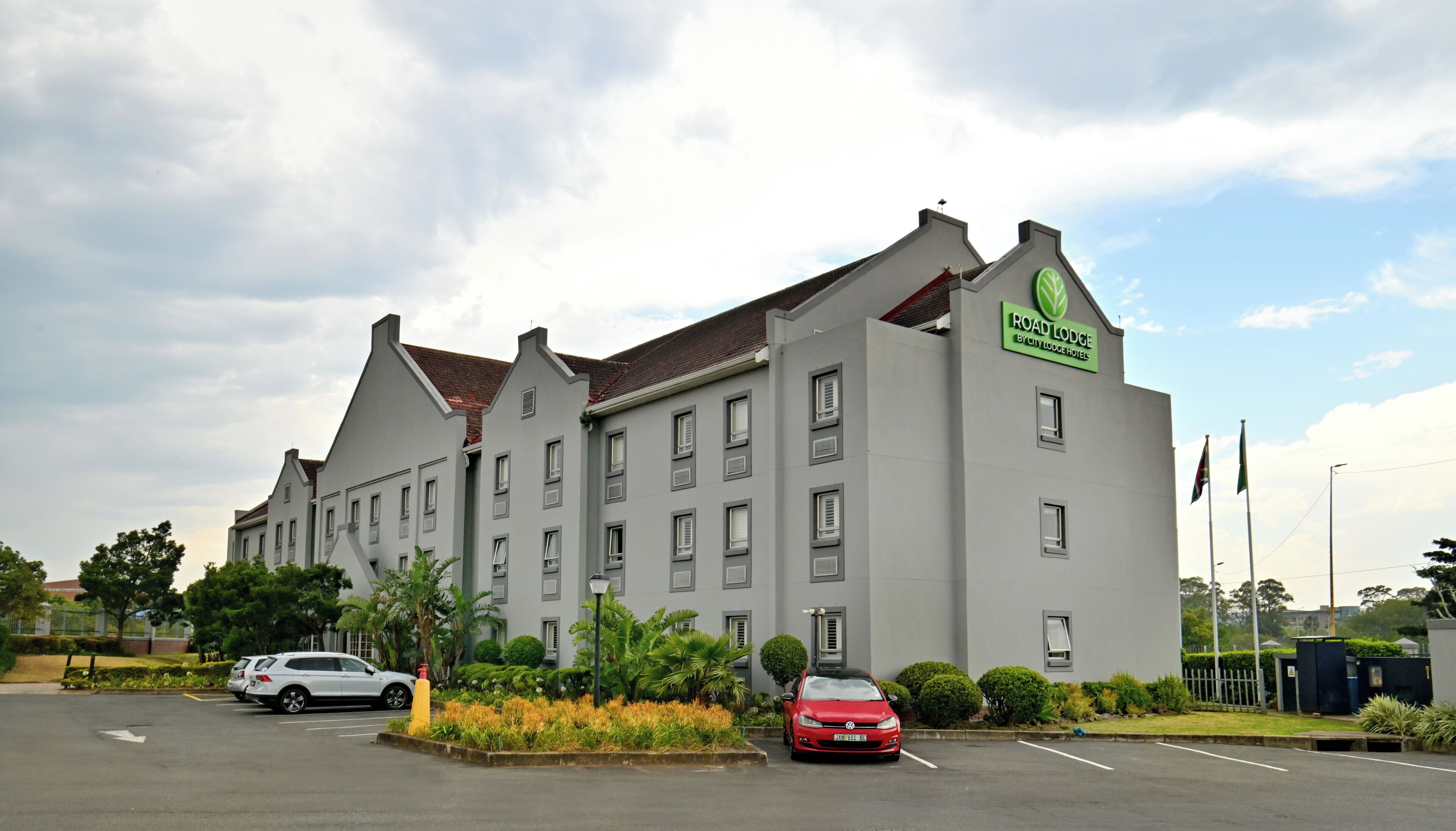 A large hotel building with a sign reading 'Road Lodge by City Lodge Hotels.'