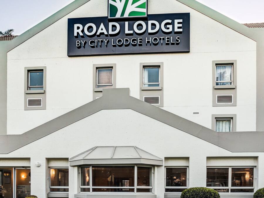 A building with a sign reading "Road Lodge by City Lodge Hotels".