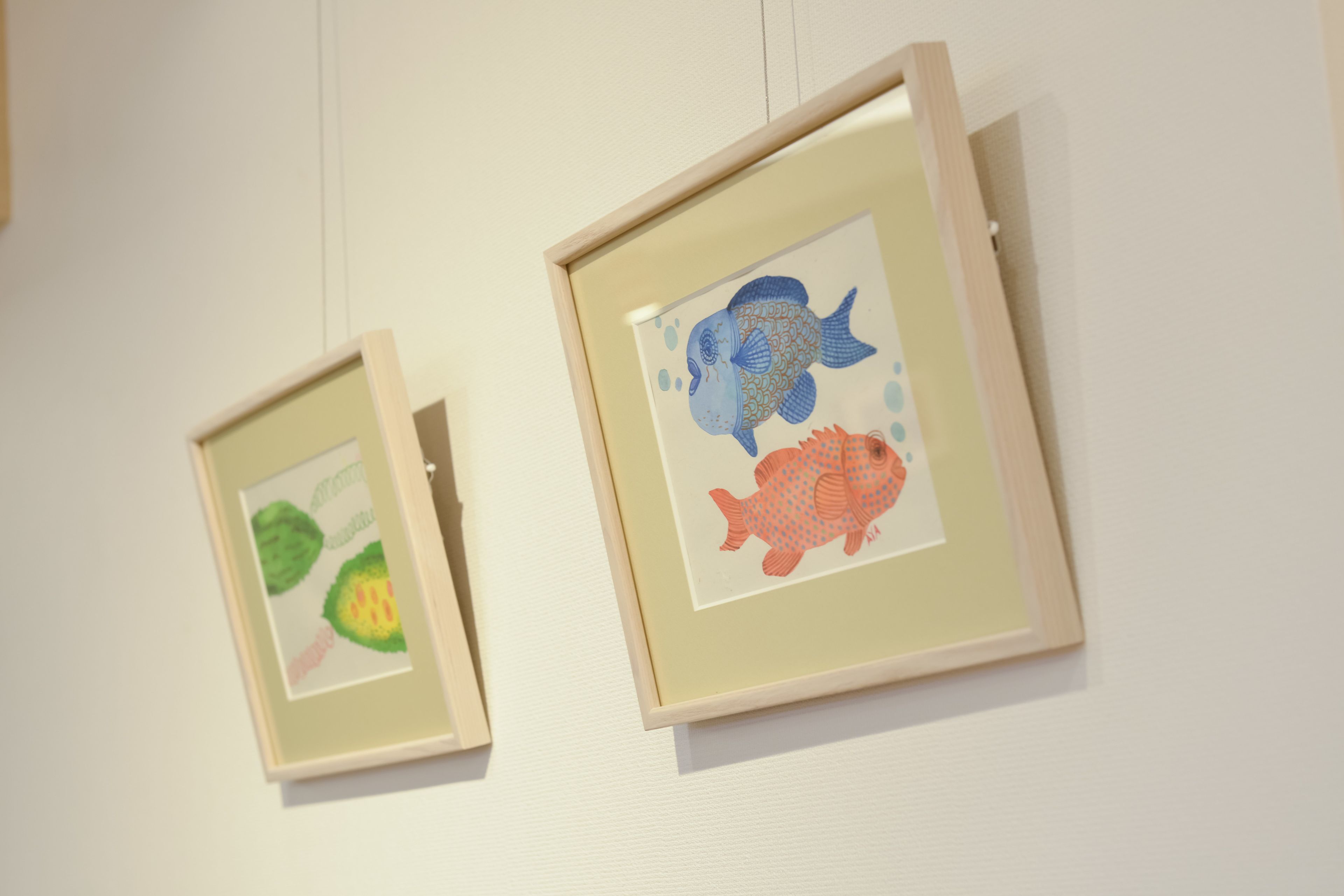 Two framed artworks on a wall.