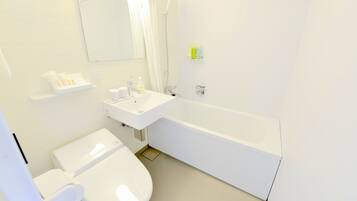 Un baño moderno con inodoro, lavamanos y bañera.