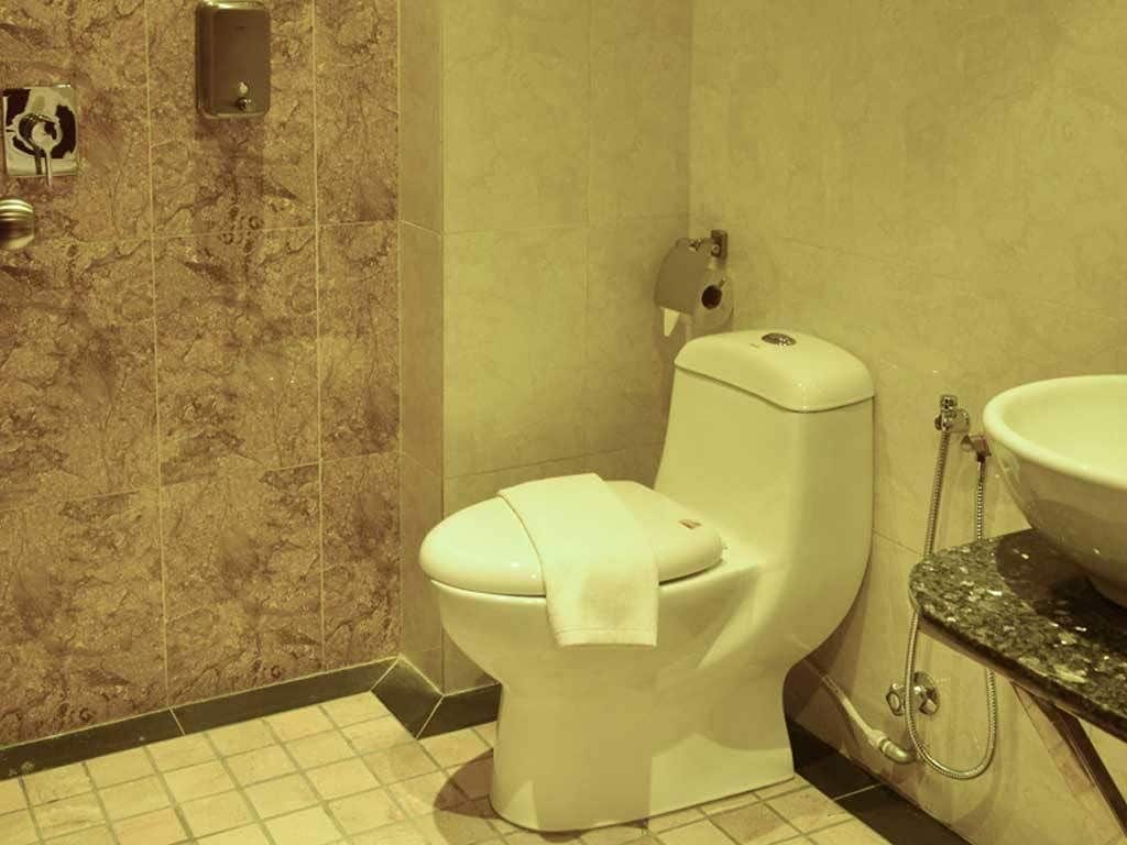 A bathroom with a toilet, a sink, and a shower.