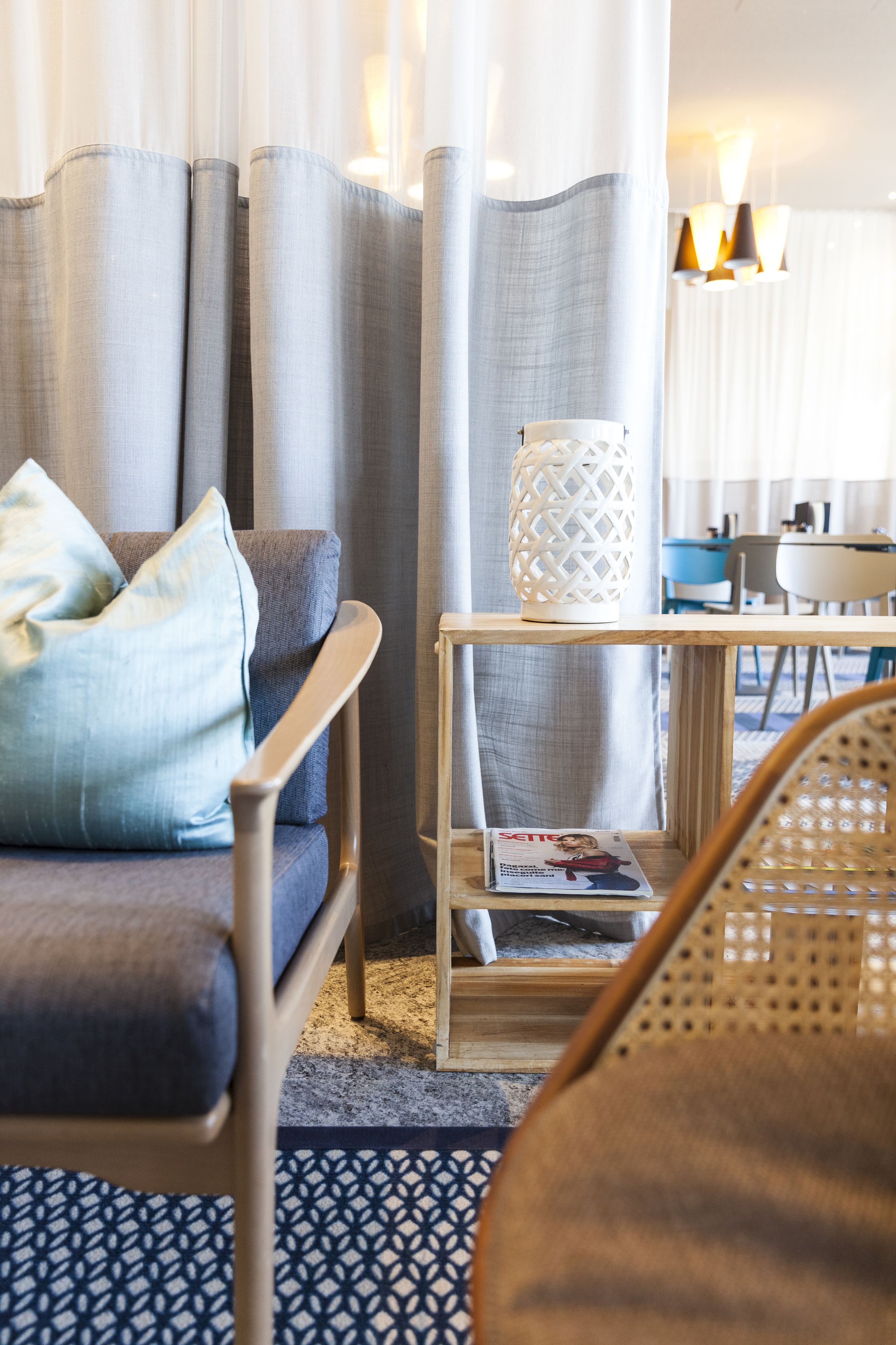 En moderne stue med sofa, sofabord og en fletstol.