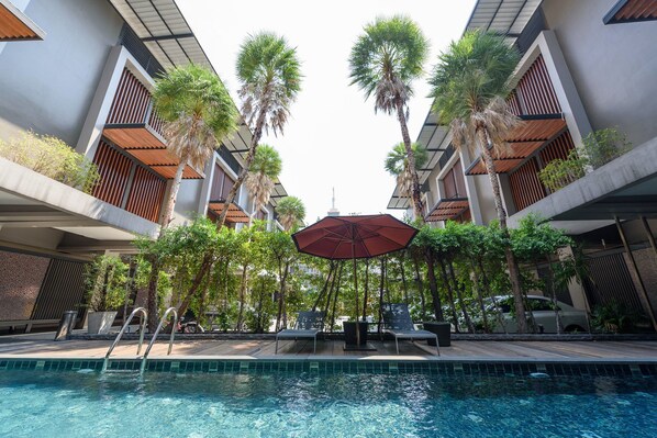 Piscine extérieure, parasols de plage, chaises longues