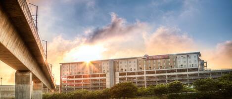 A City Lodge Hotel with a modern design, located near a highway.