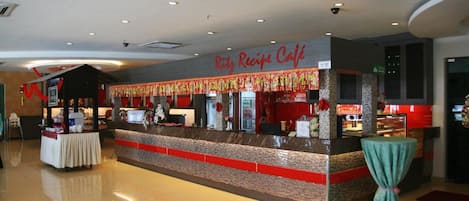 A cafe with a counter and a sign that reads "Ritz Recipe Cafe".