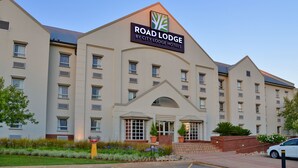 A multi-story hotel with a prominent sign reading "Road Lodge by City Lodge Hotels."