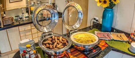 A buffet setup with various food items and condiments.