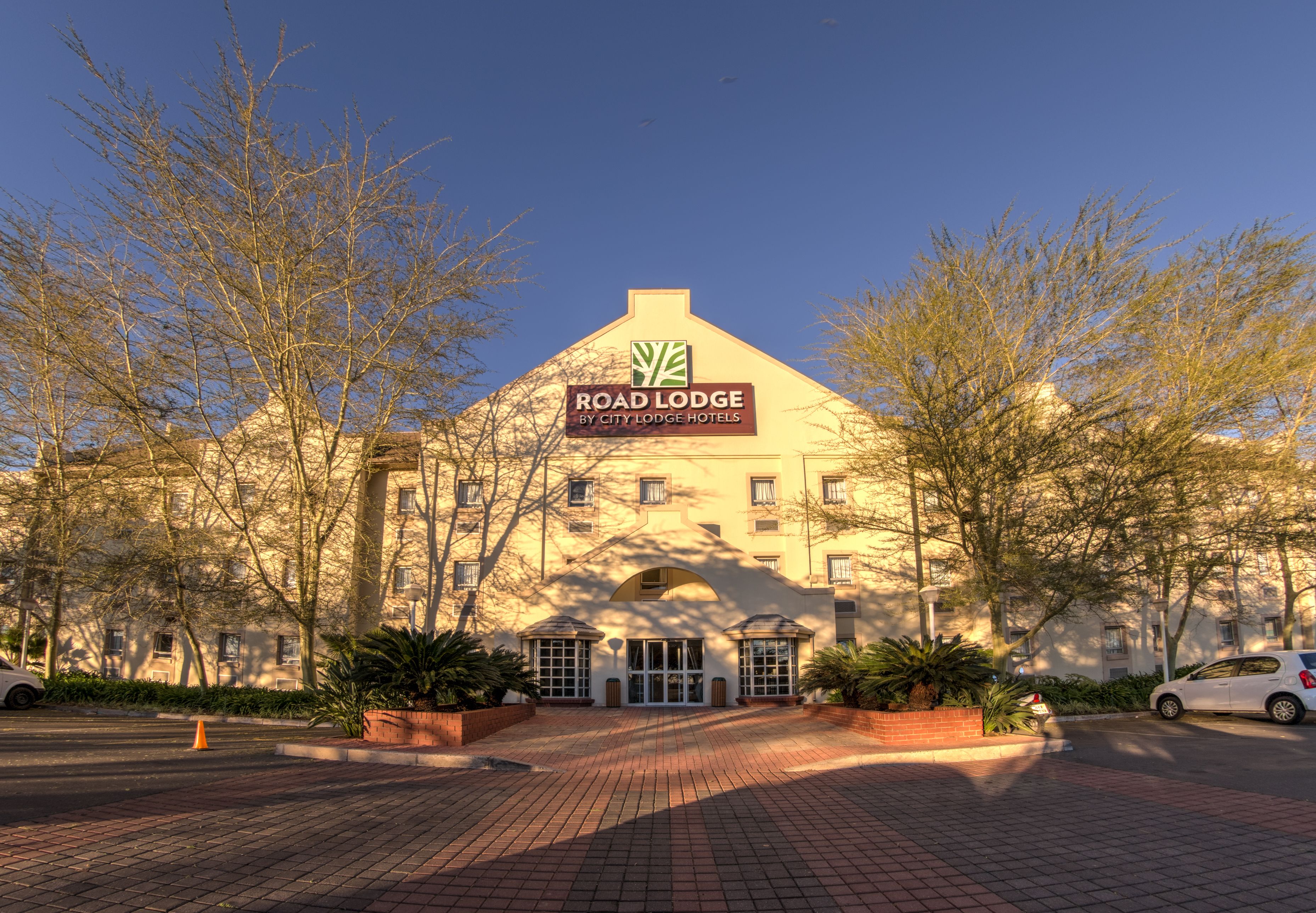 A building with a sign reading "Road Lodge by City Lodge Hotels."