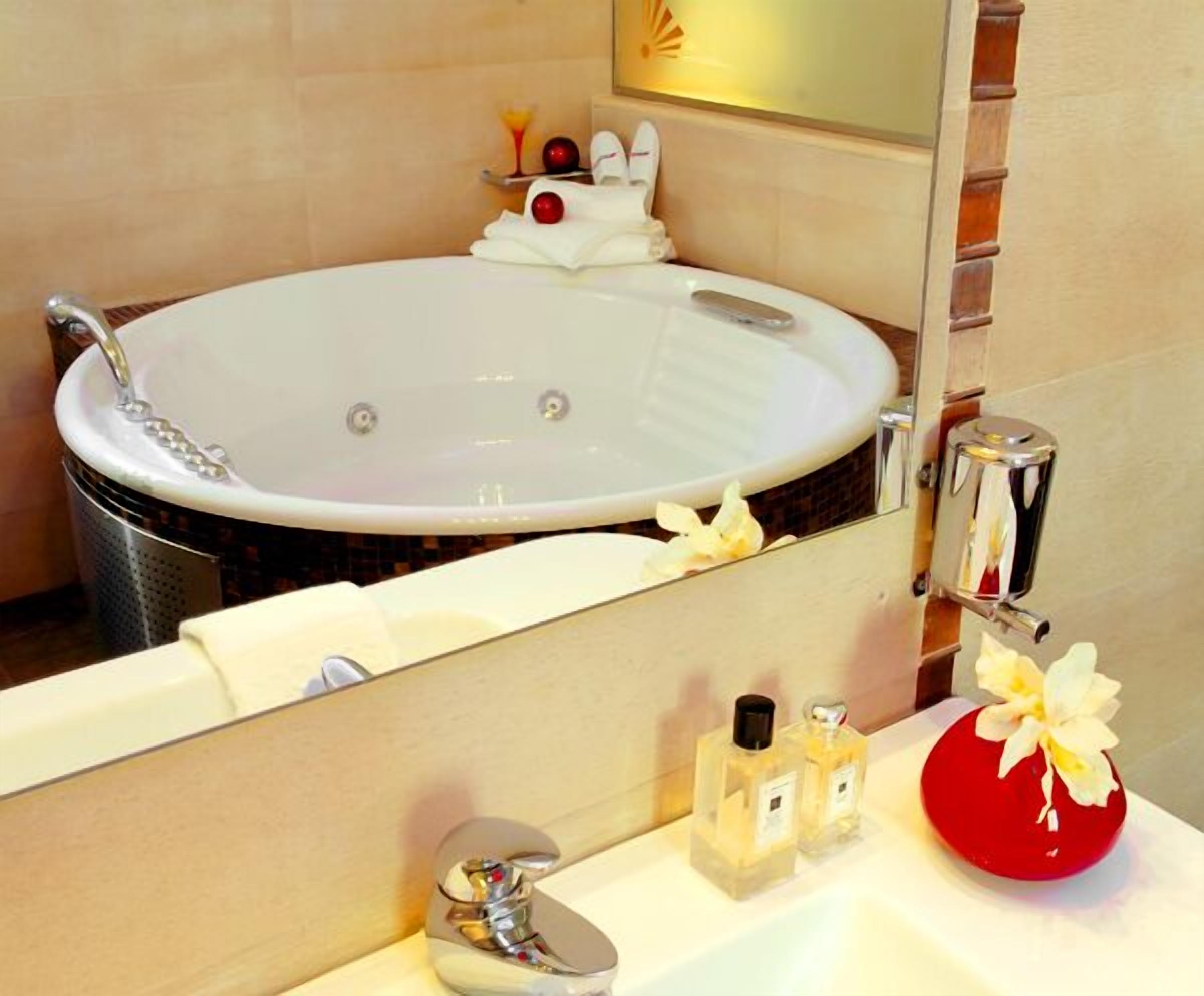 designer toiletries, hair dryer, slippers, towels