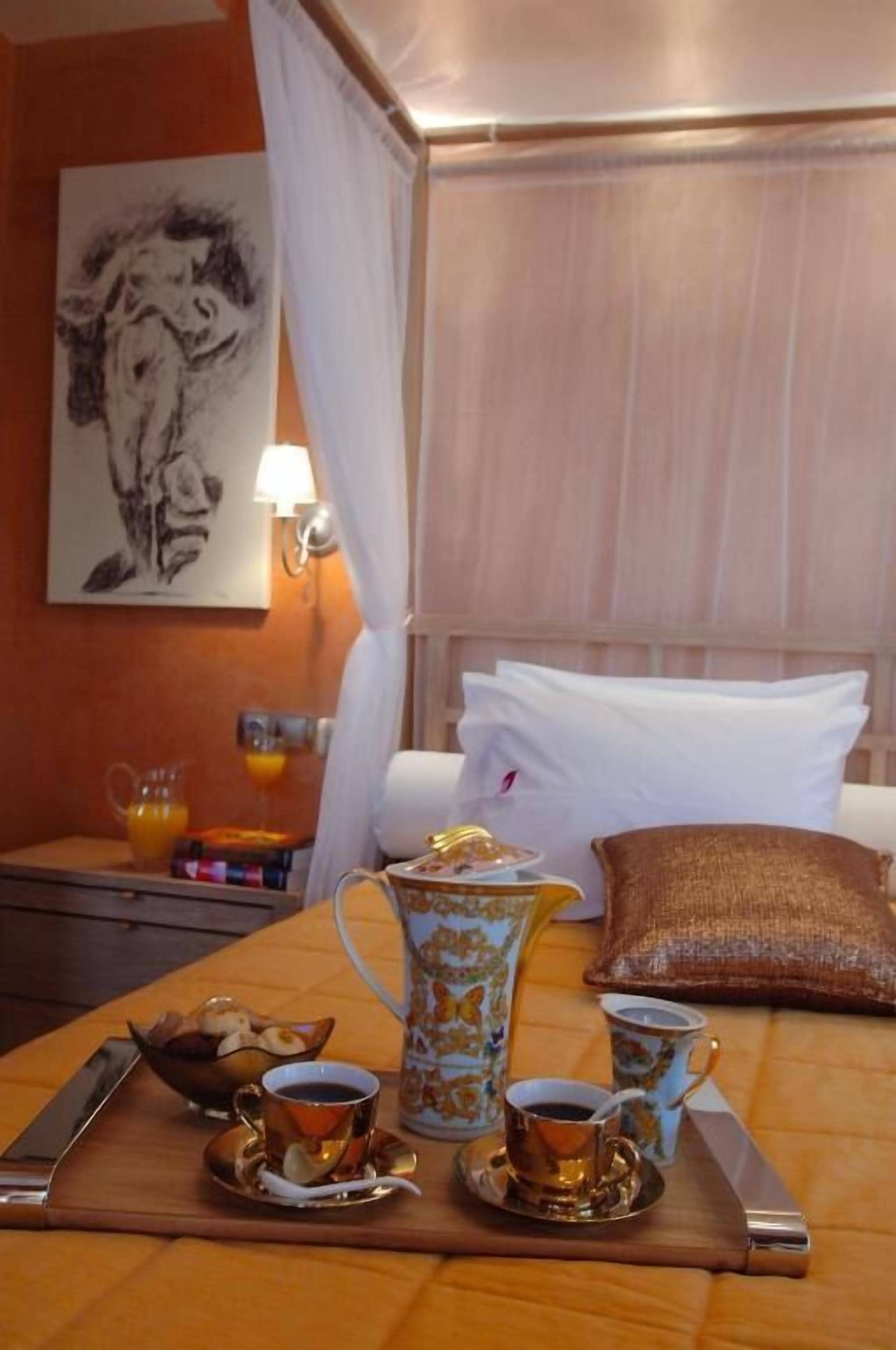 A neatly arranged breakfast table with a pitcher, cups, and a tray.