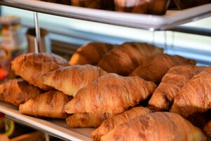 A display of freshly baked croissants in a bakery.