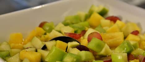 A bowl of fruit salad with various diced fruits.