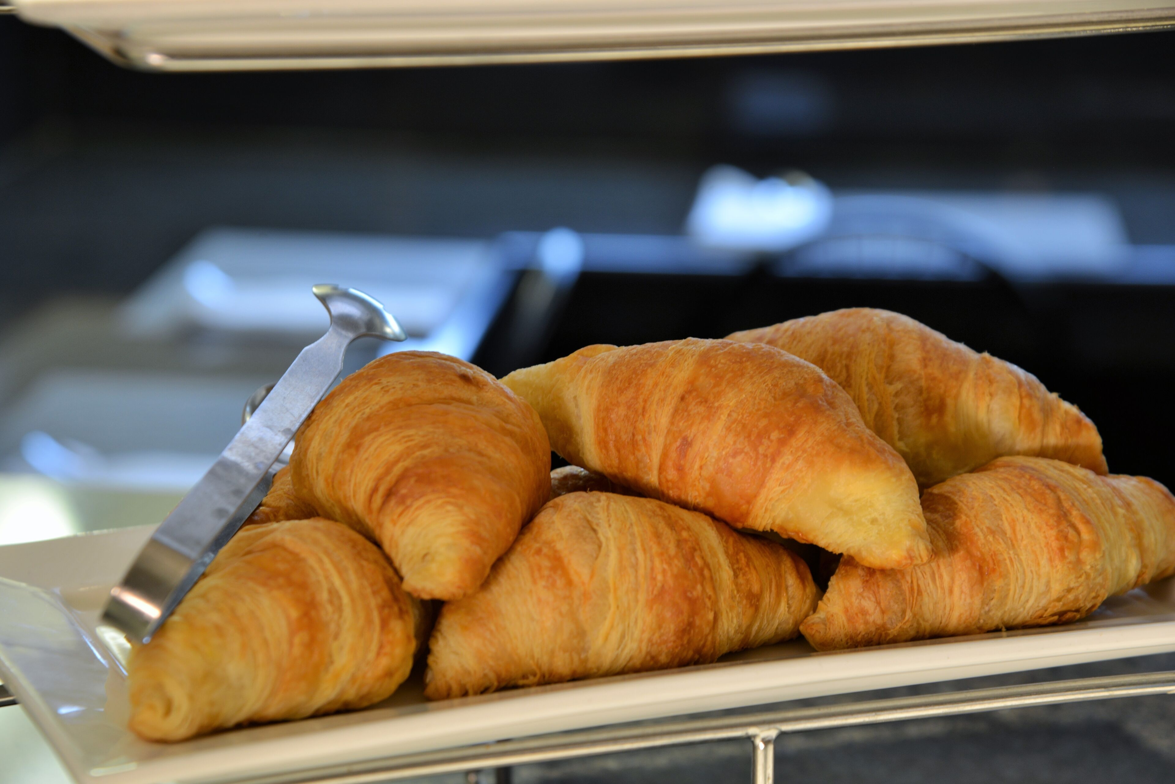 A plate of croissants on a tray.