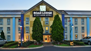 A hotel with a prominent sign reading "Road Lodge by City Lodge Hotels".