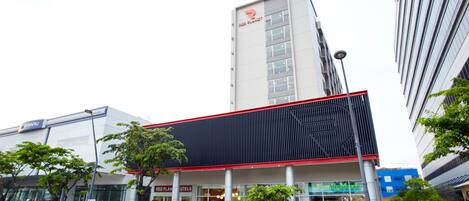 A modern building with a prominent Red Planet logo, indicating a themed hotel.