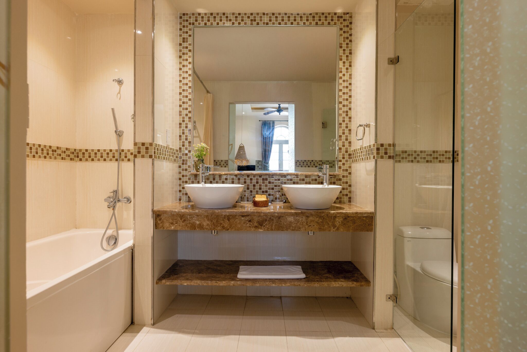 junior suite, city view | bathroom | combined shower/bathtub, rainfall showerhead, designer toiletries