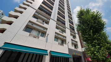 Stylish hotel building with a grid of windows and balconies, offering a contemporary urban retreat.