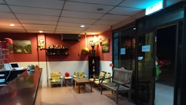 A lobby area with a reception desk, seating arrangements, and a glass door entrance. - GW Furama Apartment (Kuching)