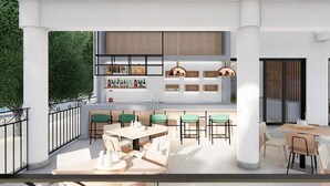 An outdoor seating area with tables and chairs, a bar with shelves of bottles, and a view of greenery. - Stemma Hotel (Corfu)