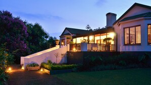 A two-story house with a balcony, a staircase, and a garden. - Highgrove House (Mbombela)