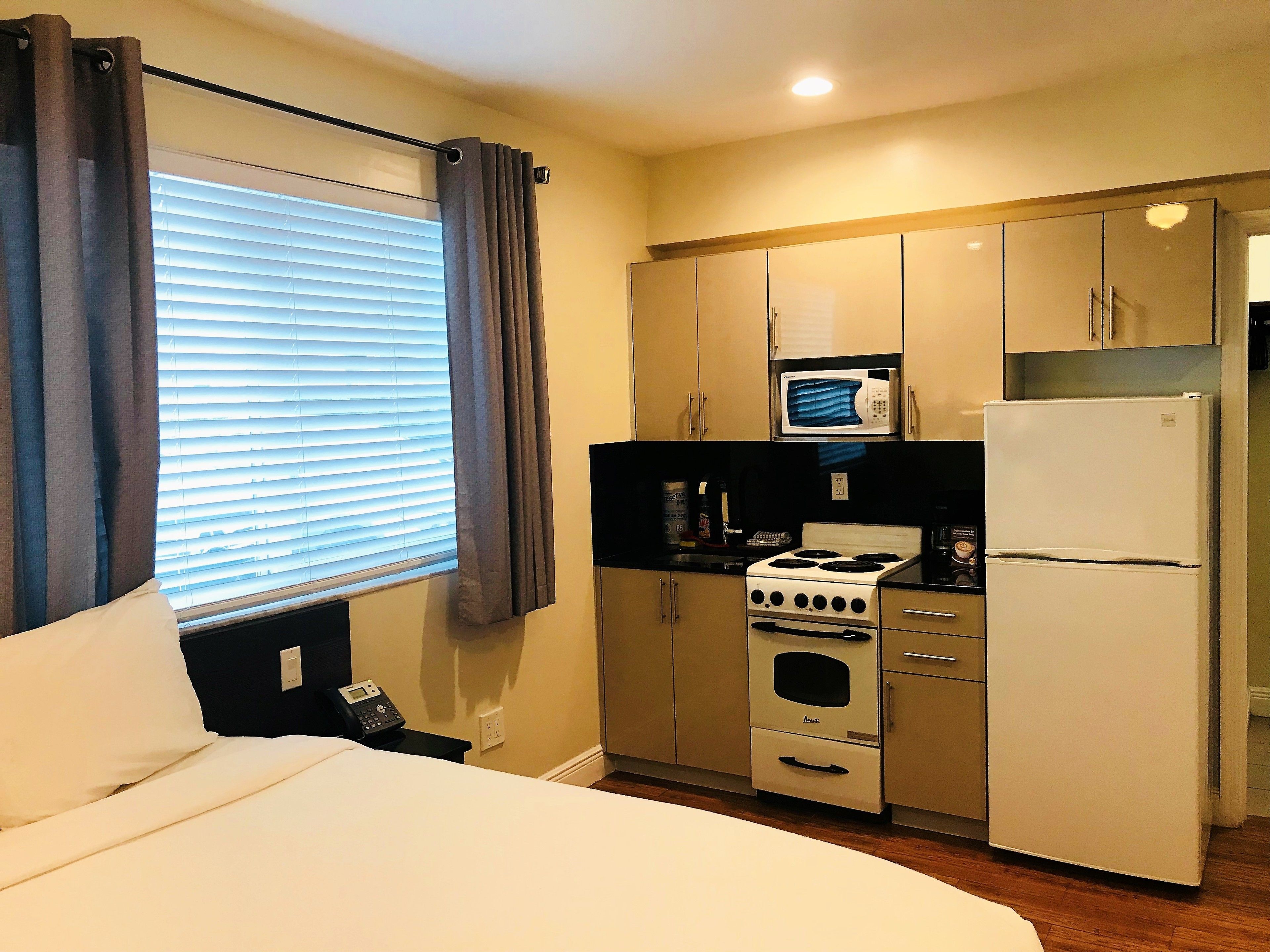 king studio pool: 1 king bed  | private kitchen | full-sized fridge, microwave, stovetop, coffee/tea maker
