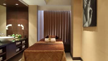 Relax in a serene space with a neatly made bed, large mirror, and wall-mounted artwork.