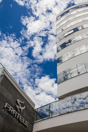 Experience the sleek, modern design of Fratelle Business Hotel, featuring a striking glass facade.