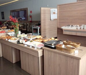 Enjoy a wide selection of fresh breads, pastries, fruits, and condiments at our buffet.