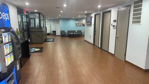 A spacious lobby with a vending machine, seating area, and a reception desk. - Days Inn by Wyndham Brooklyn Borough Park (Brooklyn)