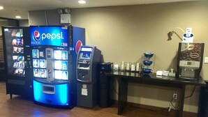 A vending machine area with a Pepsi machine, a coffee machine, and a water dispenser. - Days Inn by Wyndham Brooklyn Borough Park (Brooklyn)