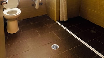 A bathroom with a toilet, sink, and shower.