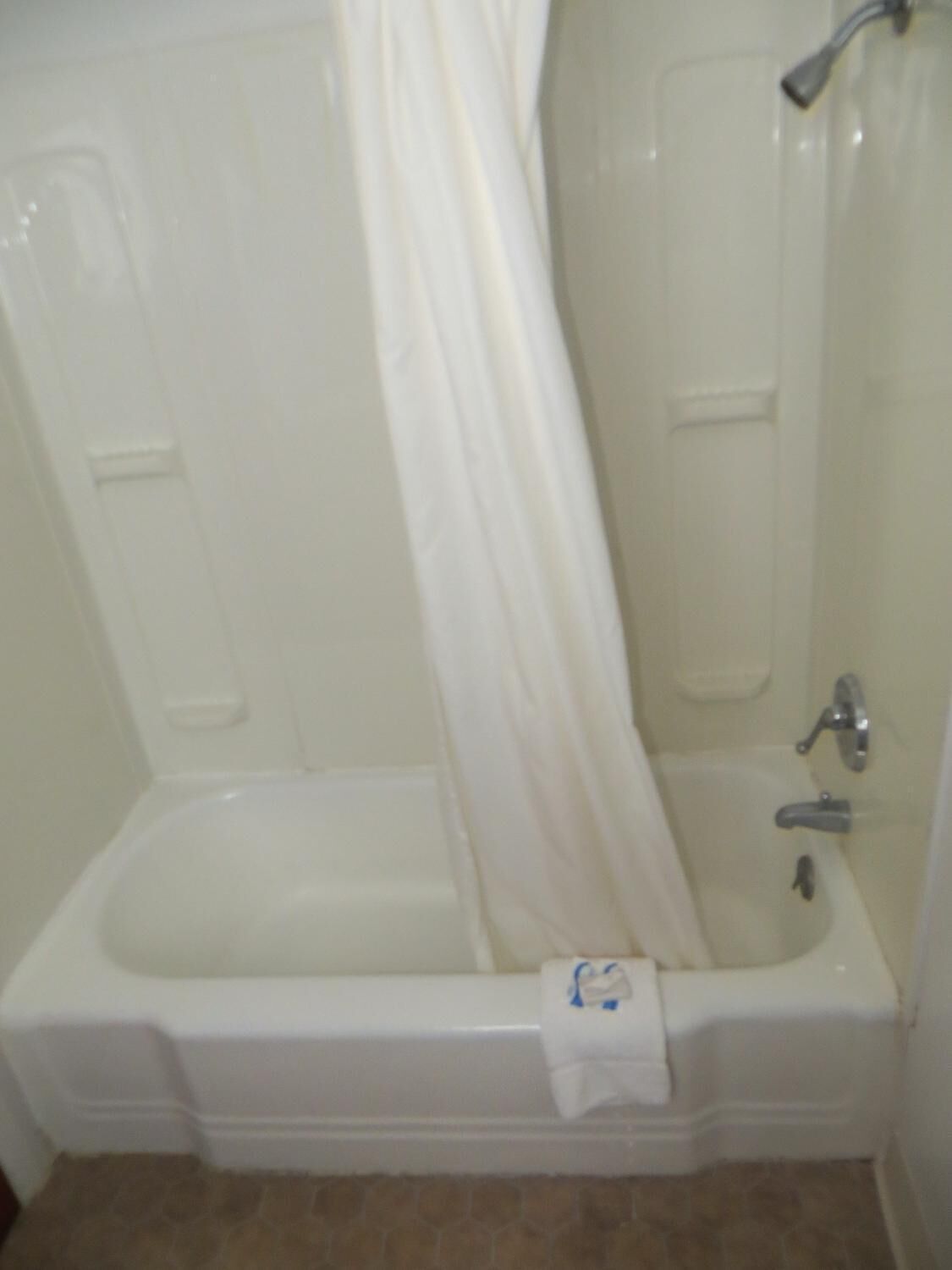 A bathroom with a bathtub, a shower, and a toilet.