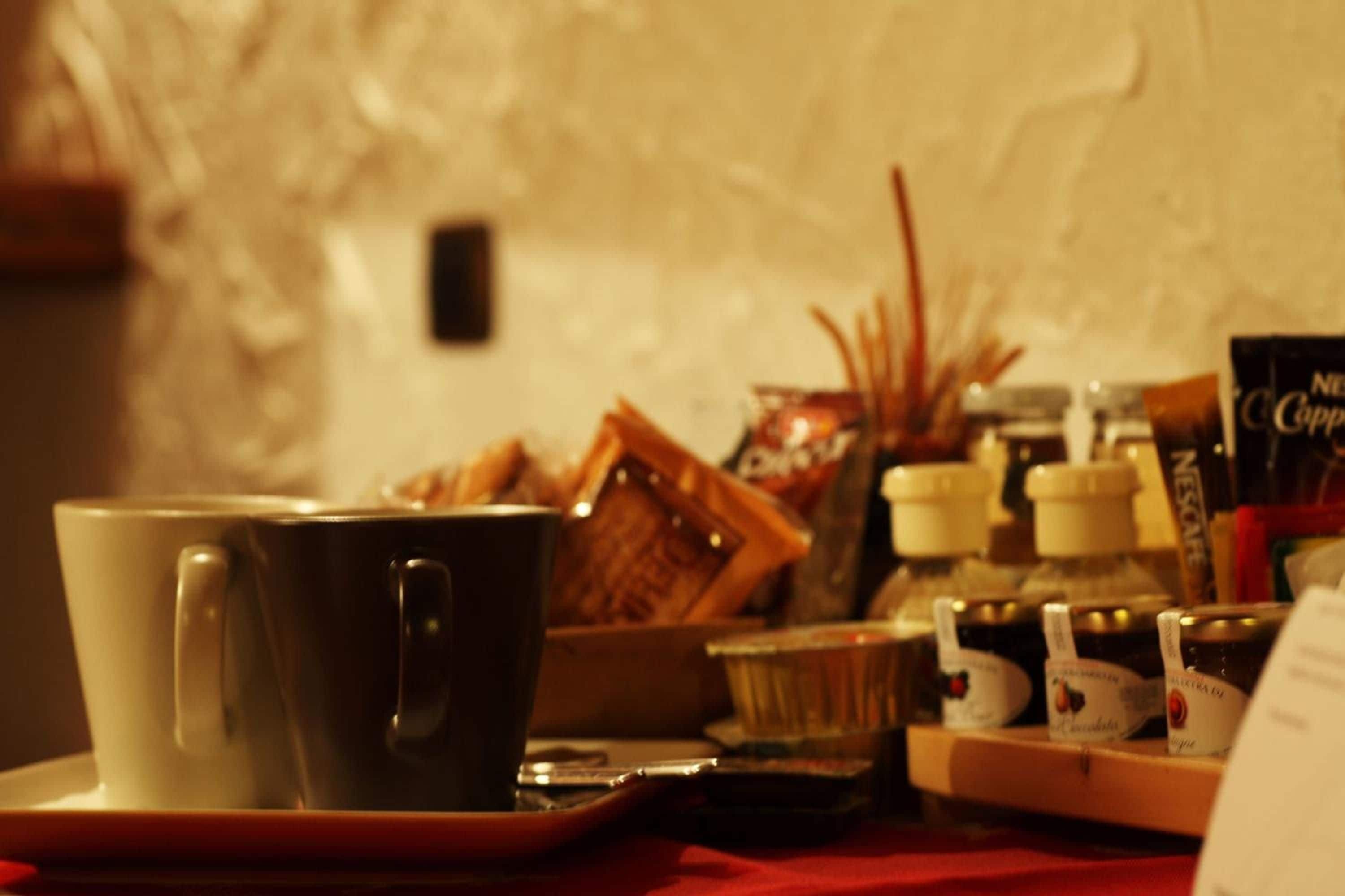 Un tavolo con una tazza, un vassoio e diversi cibi.