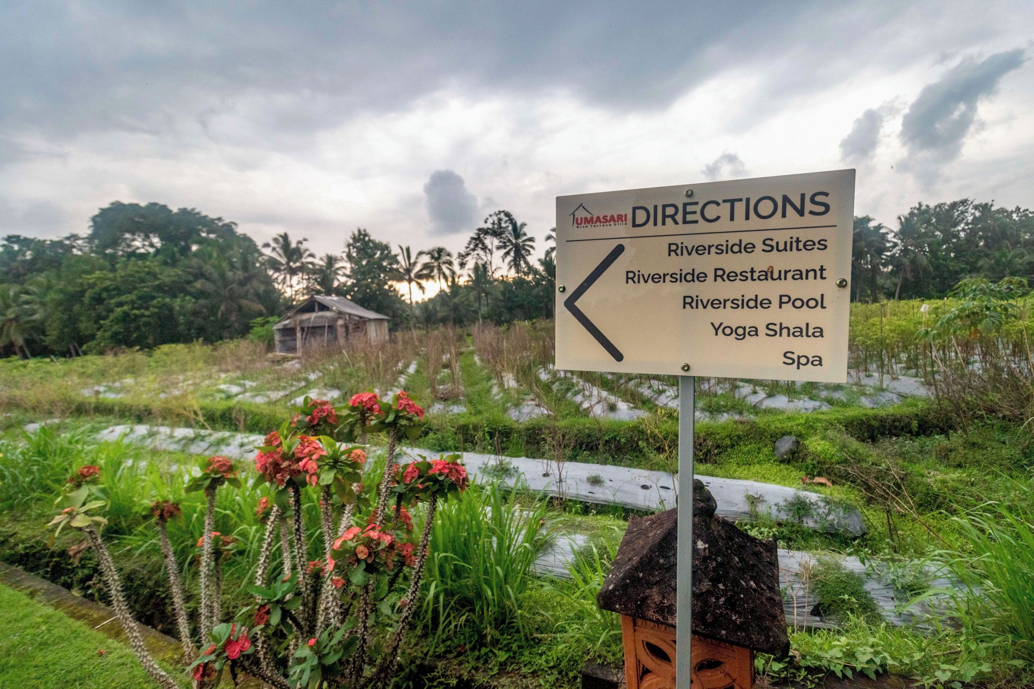 Een richtingsbord met faciliteiten zoals Riverside Suites, Riverside Restaurant, het Riverside zwembad, Yoga Shala en Spa.