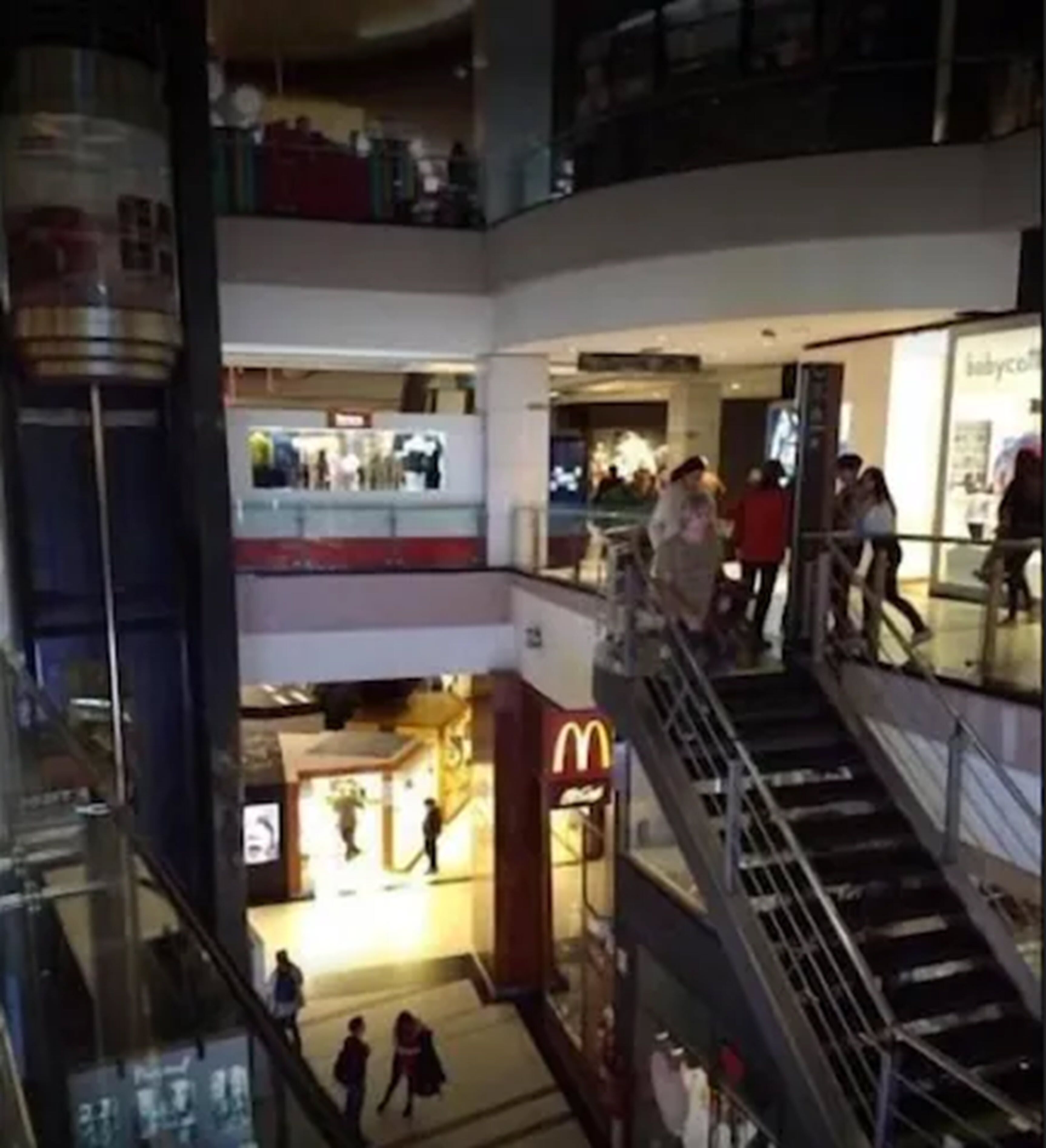 A multi-level shopping mall with various stores, including a McDonald's.