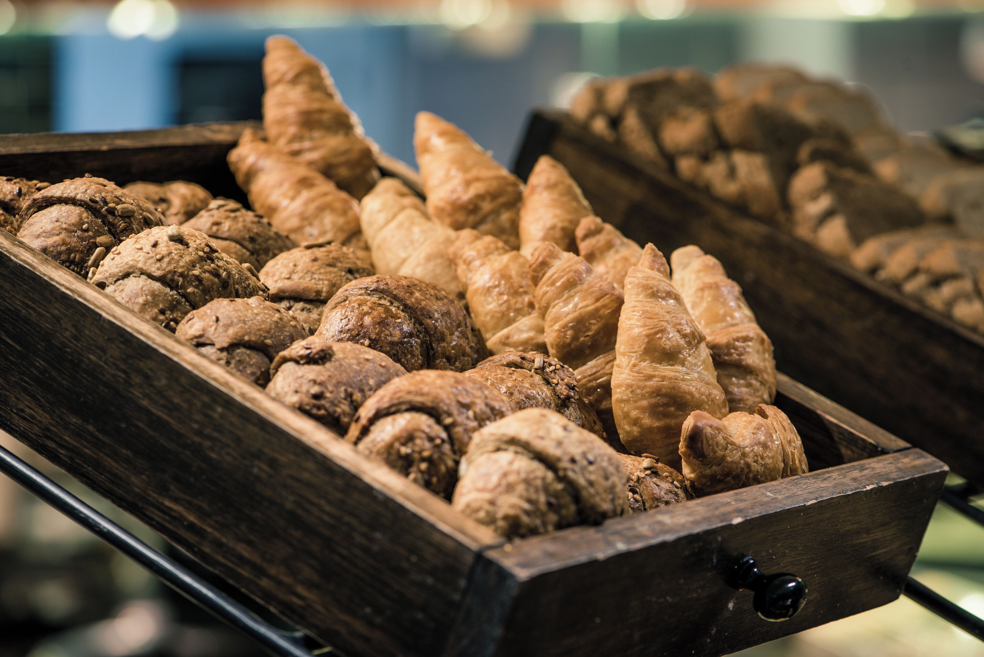 A wooden tray filled with various baked goods, including cookies and pastries.