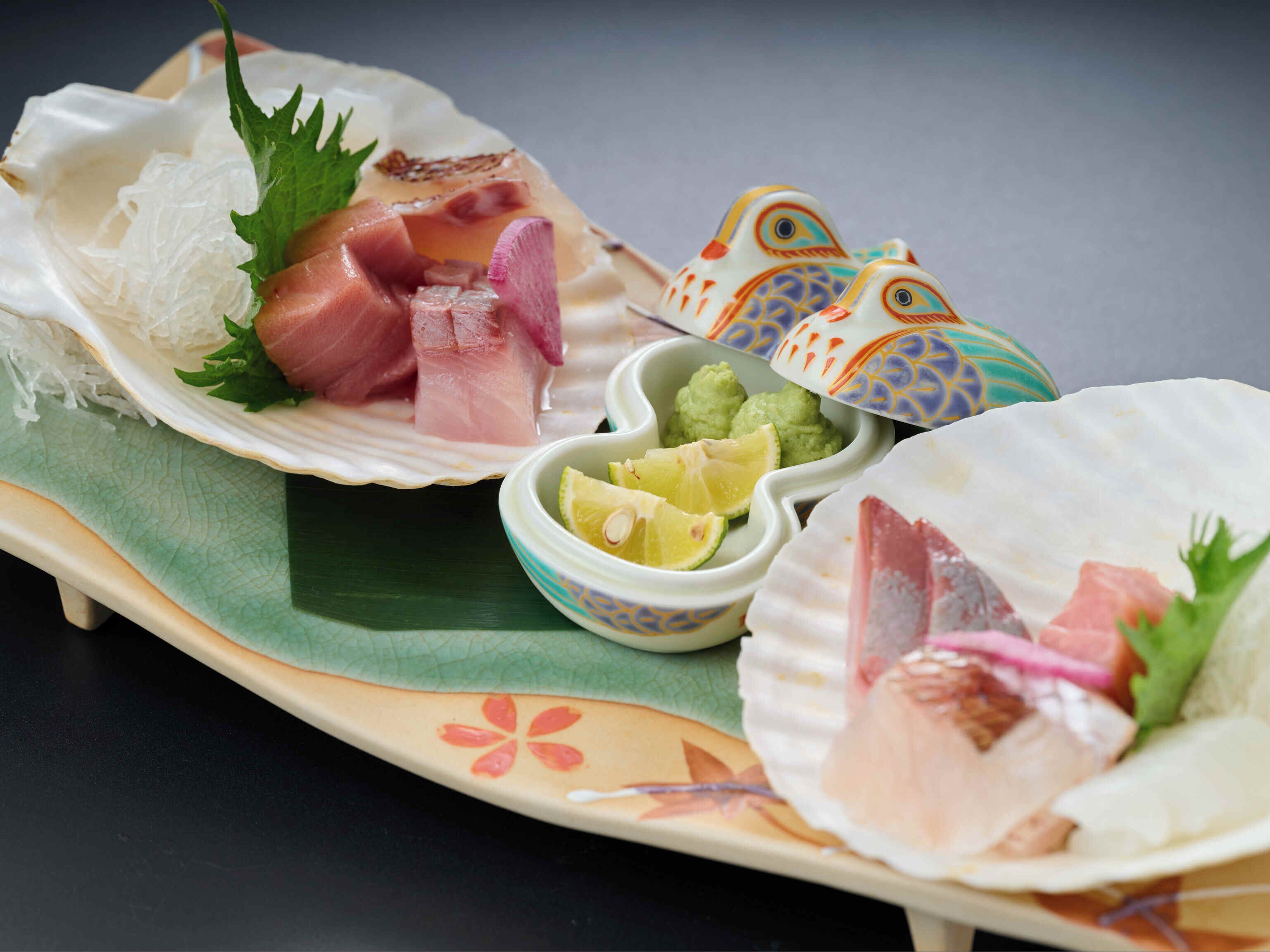 A traditional Japanese meal with sashimi, wasabi, and pickled ginger.