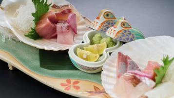 A traditional Japanese meal with sashimi, wasabi, and pickled ginger.