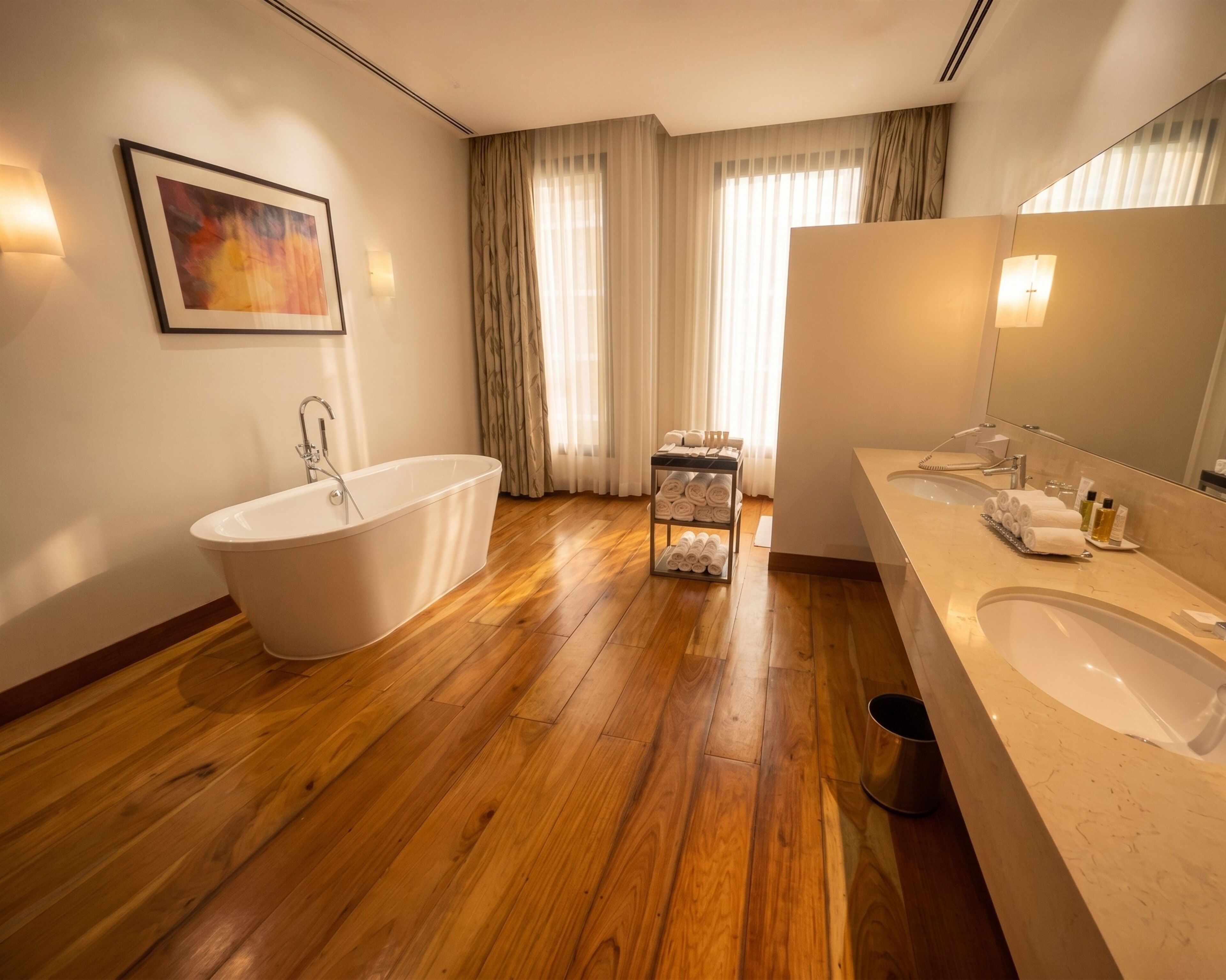 A modern bathroom with a freestanding bathtub, a vanity with a sink, and a towel rack.