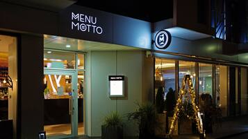 A modern building with a 'MENU' sign and a glass entrance.