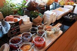 A buffet with various food items and condiments.