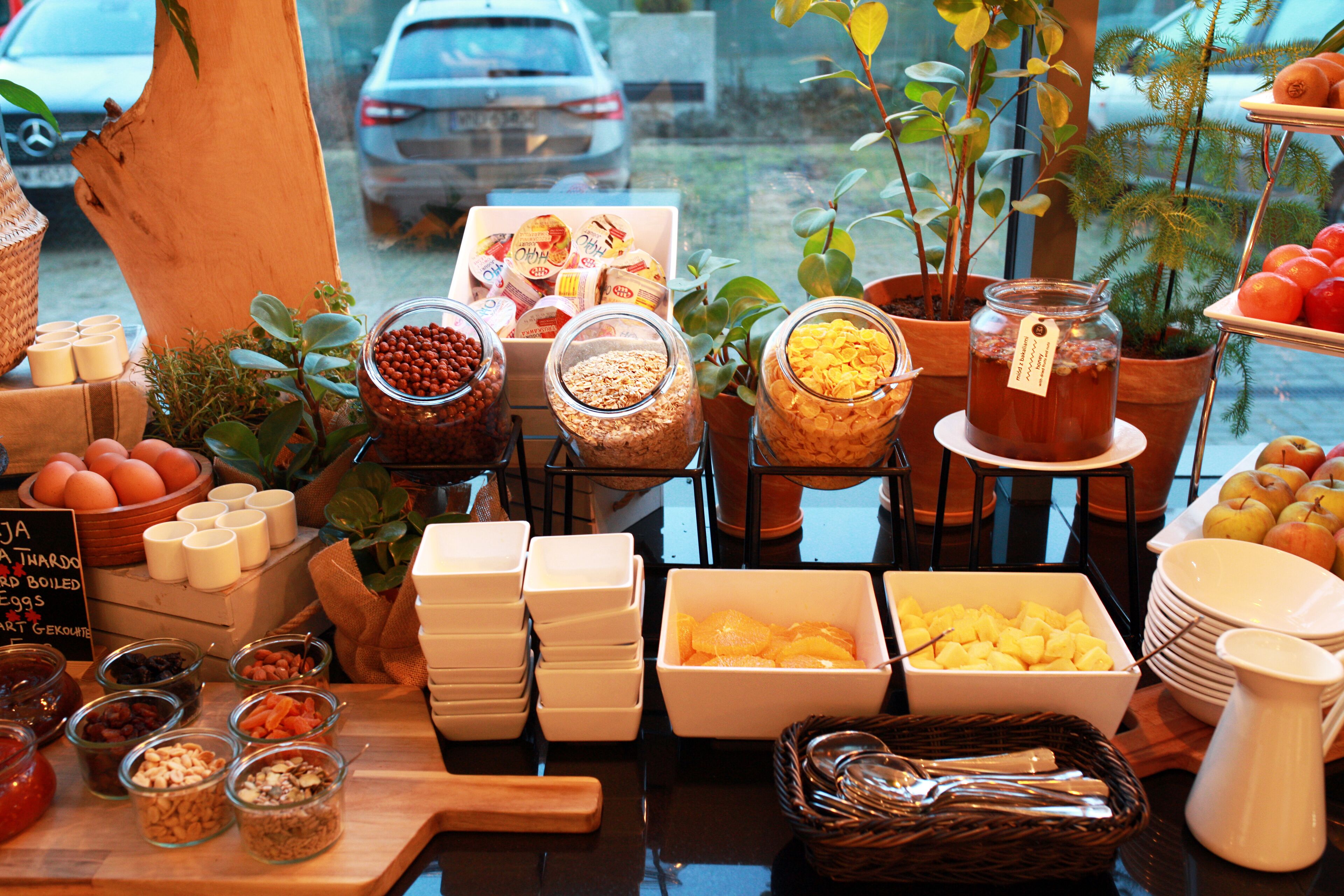 A breakfast buffet with various food items and condiments.
