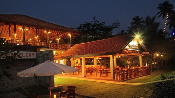 A restaurant with outdoor seating, a covered patio, and a sign that reads "GALLERY". - Wunderbar Beach Hotel (Bentota)