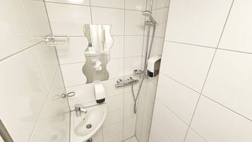 Un baño con azulejos blancos, un lavabo, un inodoro, una ducha y un perchero para toallas.