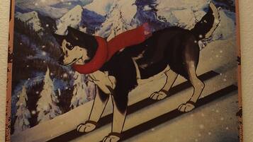 A sign for Husky Ski Club with a dog on skis and the text "Life is better on the slopes."