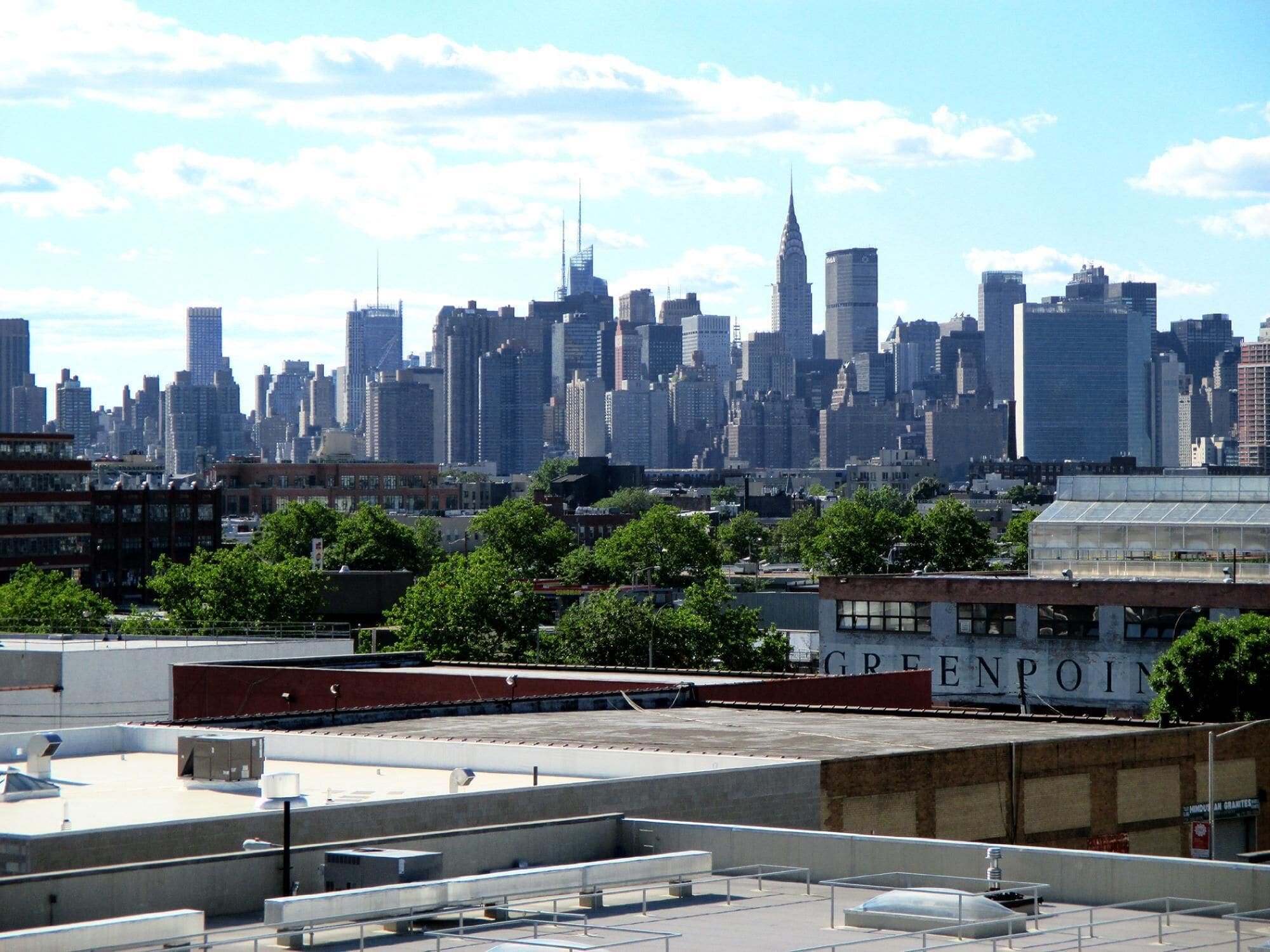 A city skyline with high-rise buildings, including a prominent skyscraper.