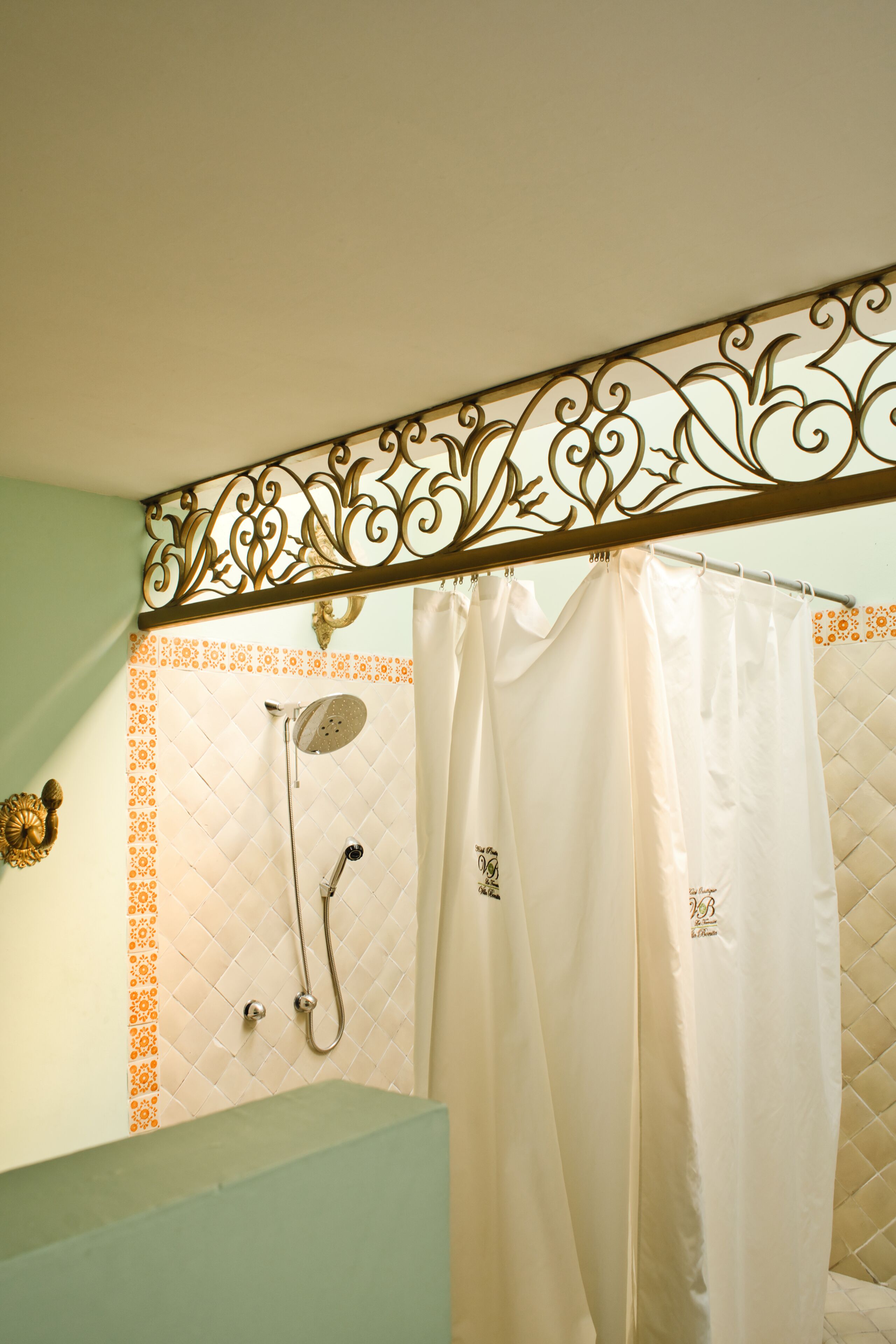 A bathroom with a shower, a toilet, and a sink.