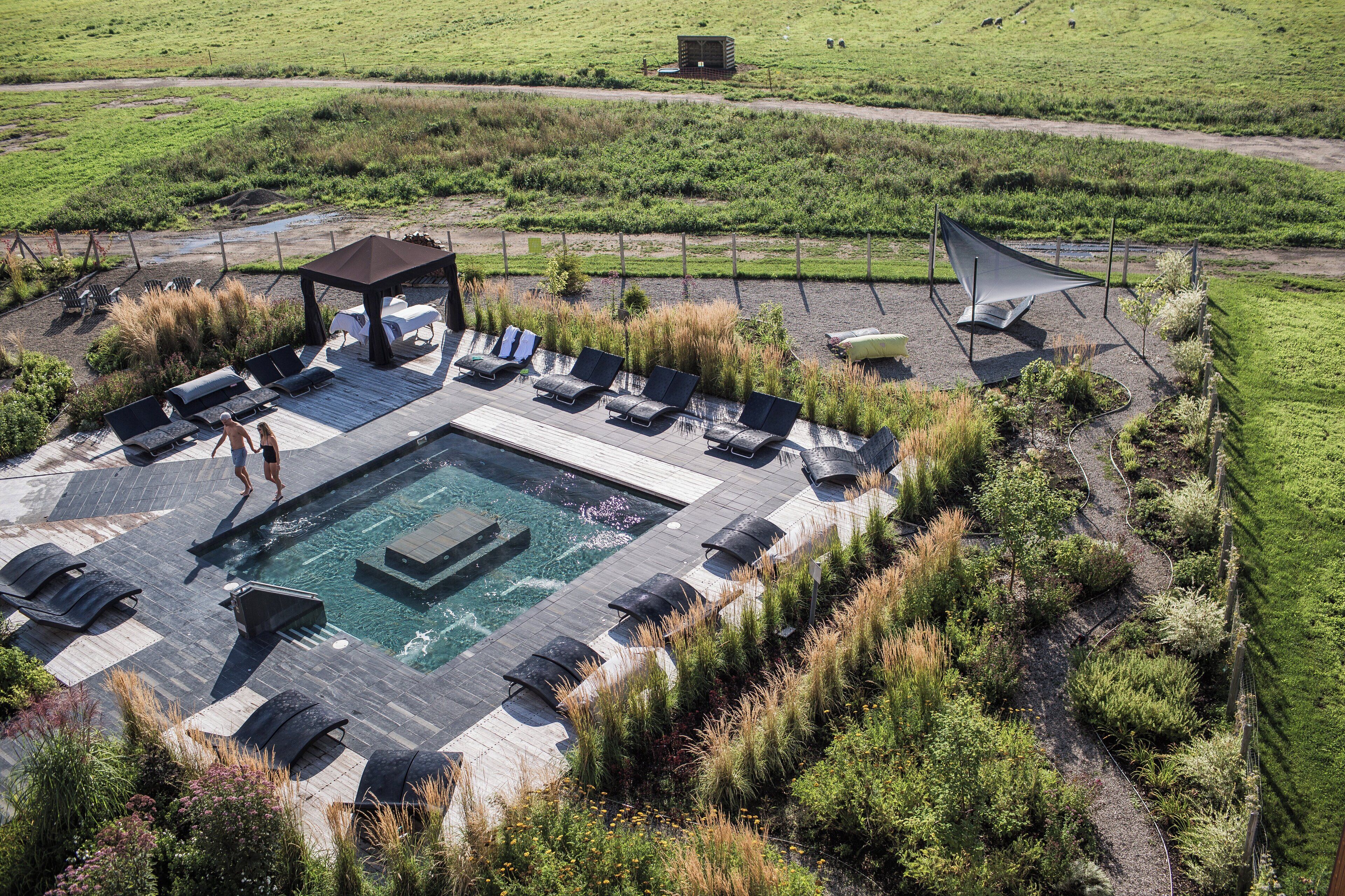 An outdoor pool area with lounge chairs and a gazebo.